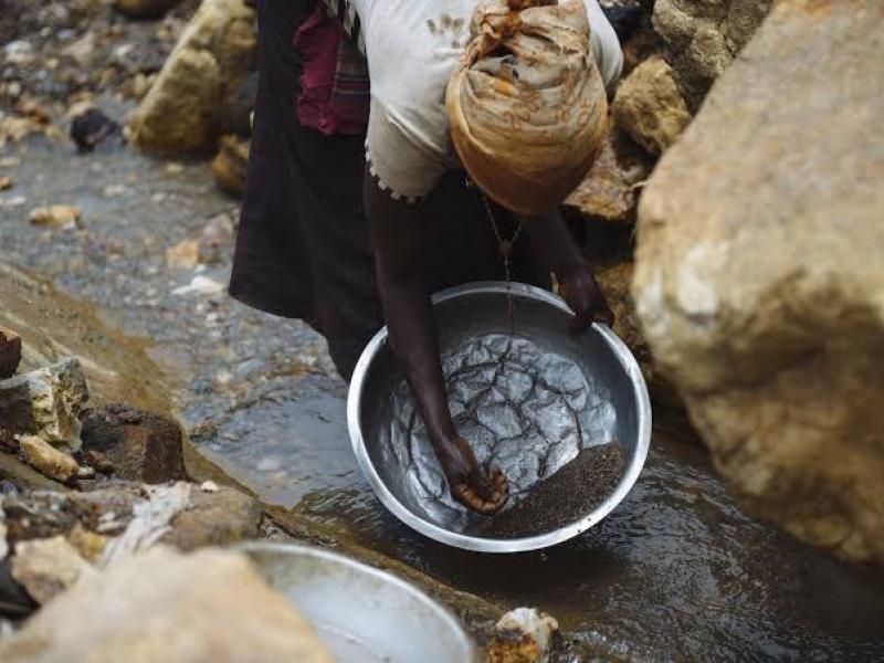 Une femme exploitant une ressource minérale dans une Zone d'Exploitation Artisanale [Photo d'illustration]