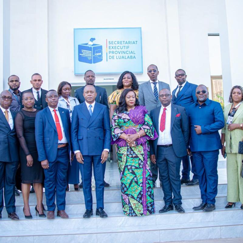 Le Président de la CENI Denis Kadima pose avec quelques responsables de la centrale électorale devant le nouveau bâtiment administratif de la CENI au Lualaba