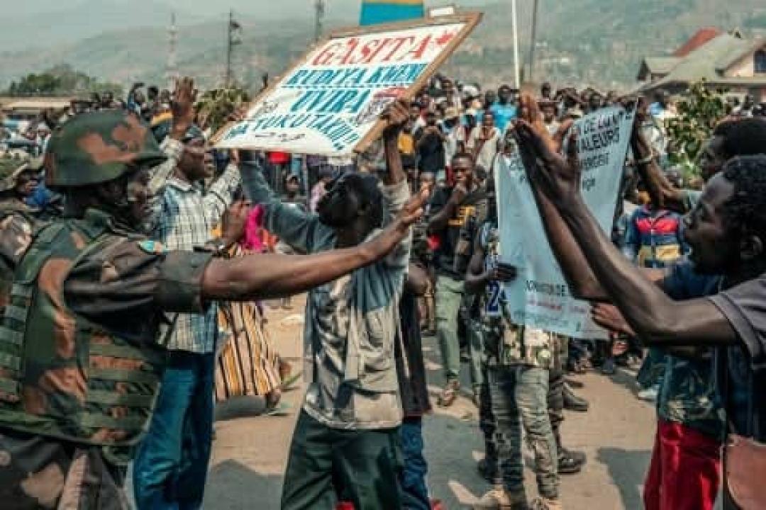 Un militaire congolais tente de calmer des manifestants en colère qui réclament le départ du général Olivier Gasita à Uvira.