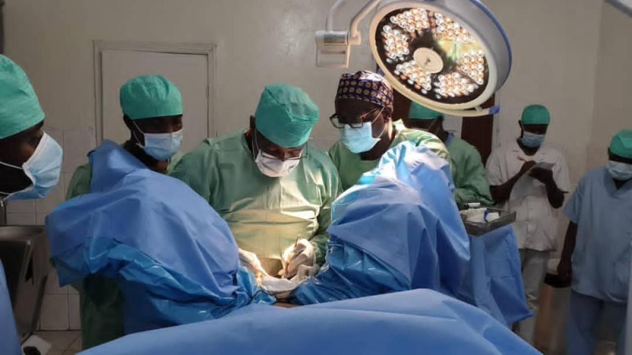 Médecin et assistants effectuant une chirurgie [Photo d'illustration]